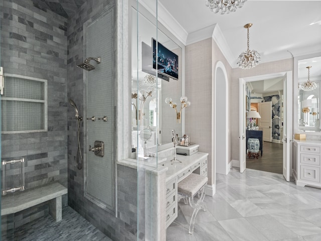 bathroom featuring ornamental molding, a shower with shower door, a chandelier, and vanity