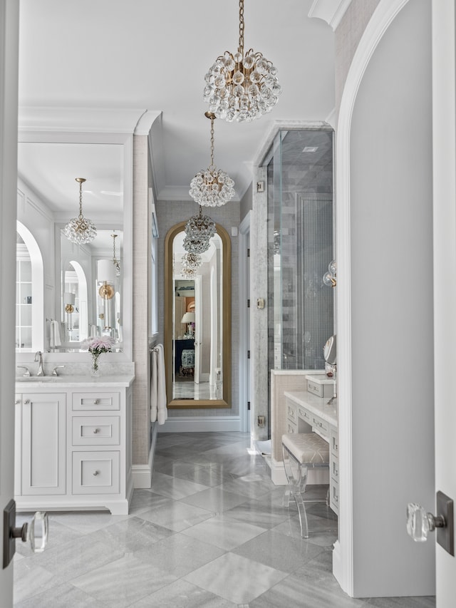 bathroom with ornamental molding, walk in shower, vanity, and a chandelier