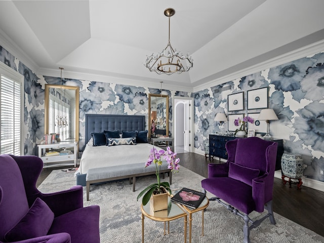 bedroom with a chandelier, hardwood / wood-style floors, lofted ceiling, a tray ceiling, and ornamental molding