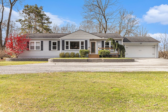 single story home featuring a front lawn and a garage