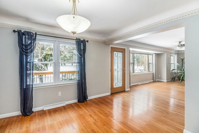 spare room with ceiling fan, light hardwood / wood-style floors, ornamental molding, and a wealth of natural light