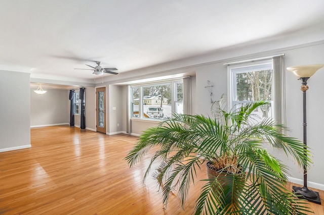 spare room with light wood-type flooring and ceiling fan