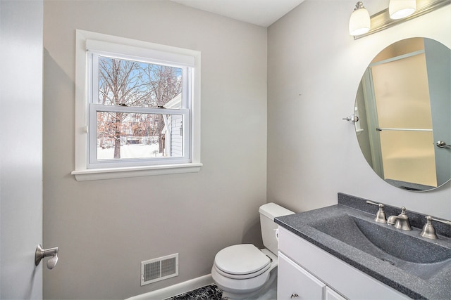 bathroom featuring toilet and vanity