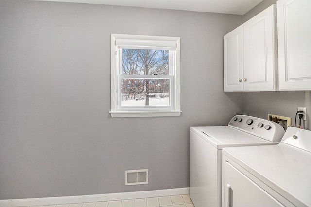 washroom featuring separate washer and dryer and cabinets