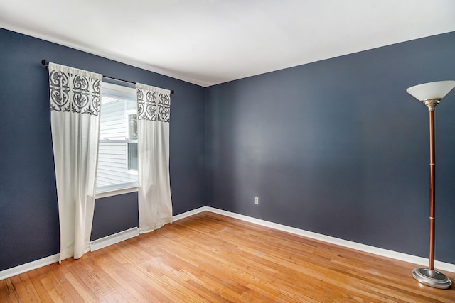 unfurnished room with hardwood / wood-style flooring