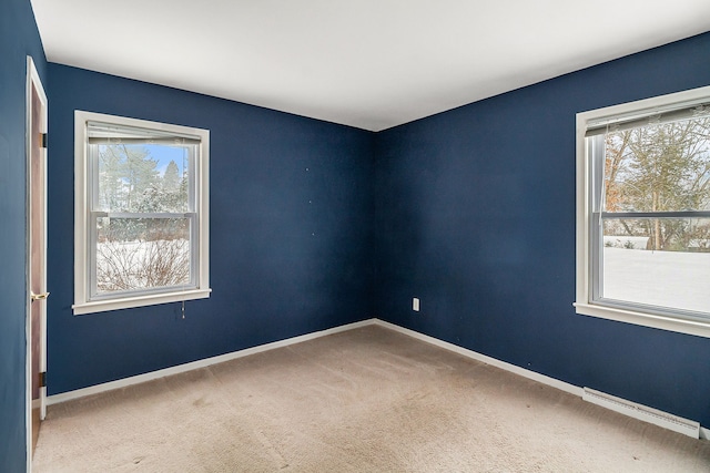 carpeted spare room with baseboard heating