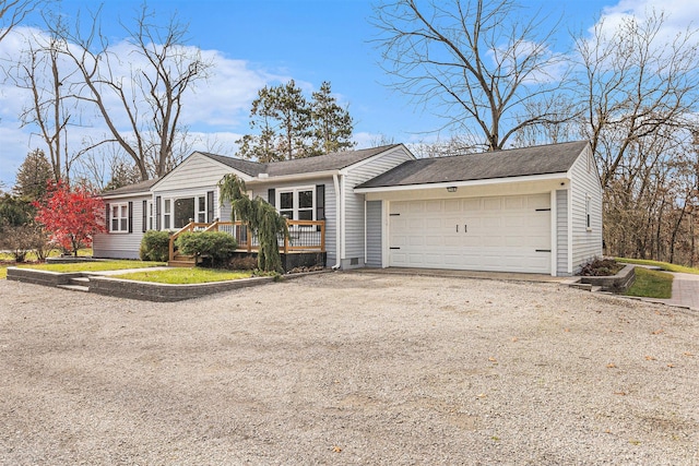 single story home featuring a deck and a garage