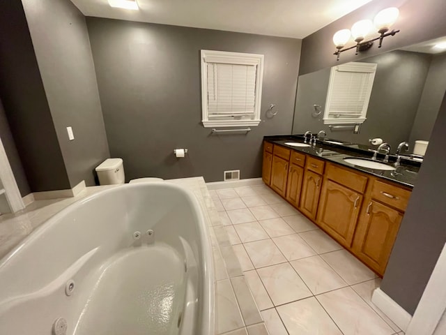 bathroom with tile patterned floors, vanity, and a tub