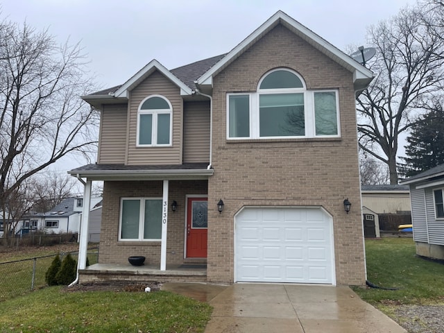 view of front property with a garage and a front lawn