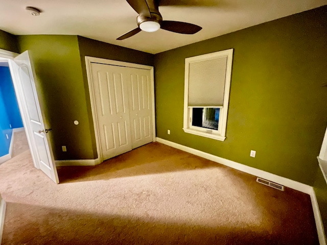 unfurnished bedroom featuring a closet, ceiling fan, and carpet flooring