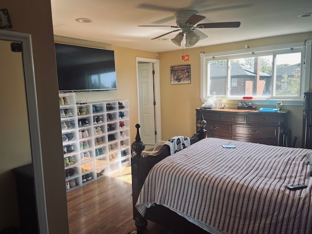 bedroom with wood-type flooring and ceiling fan