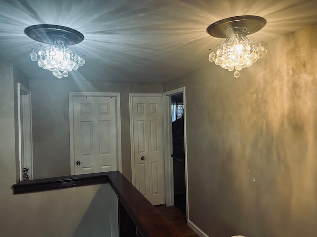 corridor featuring hardwood / wood-style floors and a chandelier