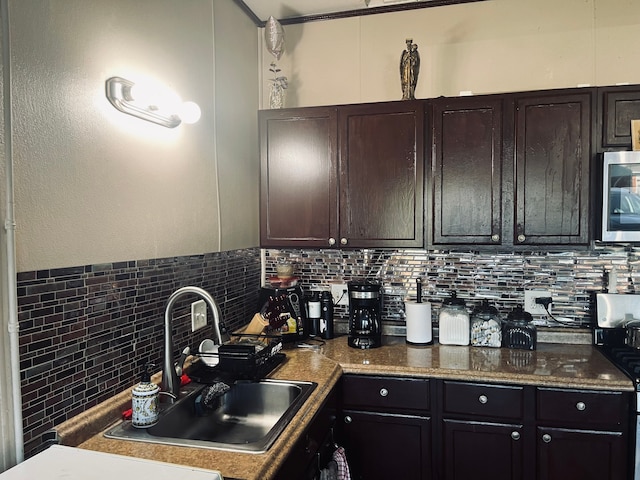 kitchen featuring sink, dark brown cabinetry, and decorative backsplash