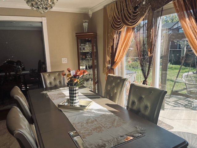 dining area with a notable chandelier and crown molding