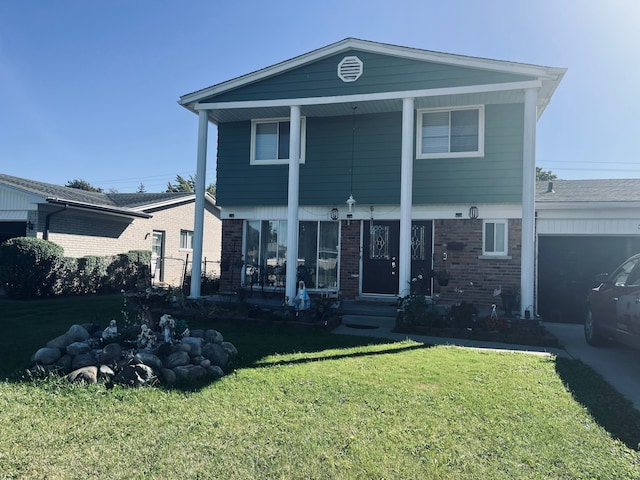 view of front of house with a garage and a front yard