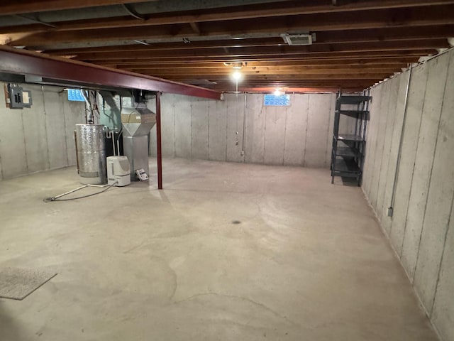 basement with water heater and electric panel