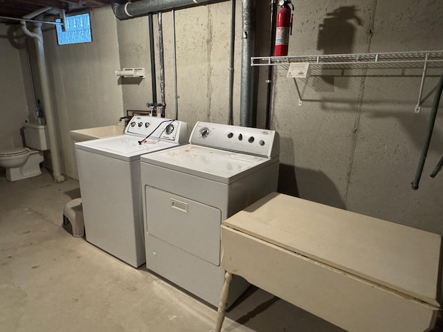 clothes washing area featuring washer and dryer and sink