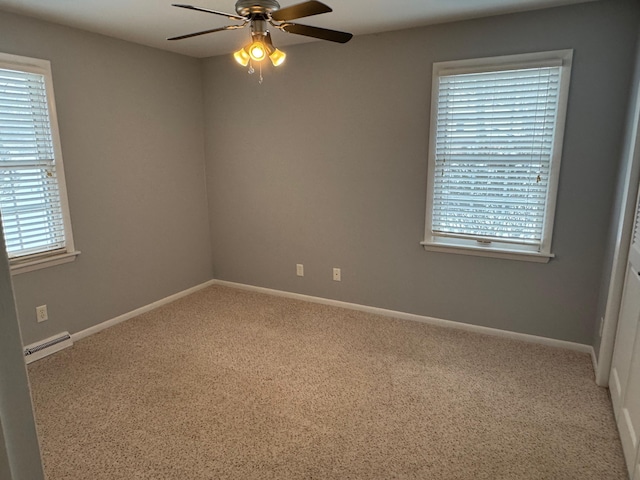 carpeted empty room featuring ceiling fan and a wealth of natural light