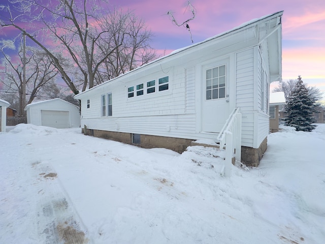 view of front of home featuring a garage and an outdoor structure