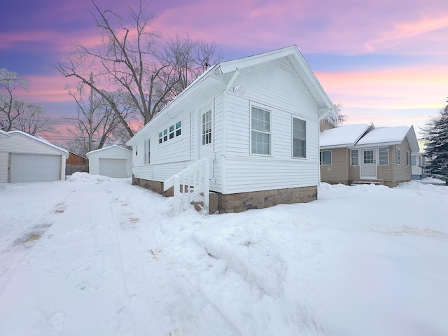 view of front of property featuring a garage and an outdoor structure