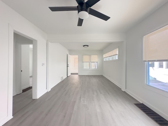 unfurnished room featuring ceiling fan, light hardwood / wood-style flooring, and a wealth of natural light