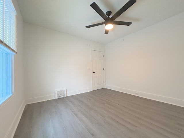 unfurnished room with ceiling fan and hardwood / wood-style flooring