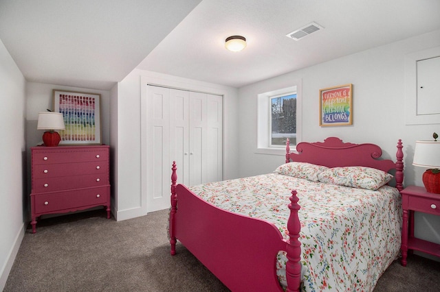 bedroom with a closet and dark colored carpet