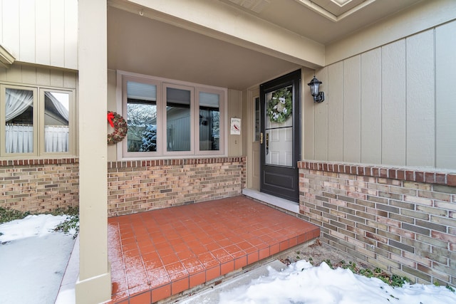 view of snow covered property entrance