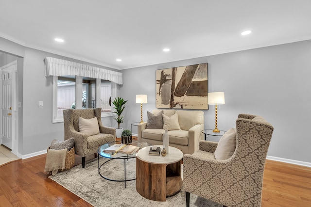 living room with light wood-type flooring and ornamental molding