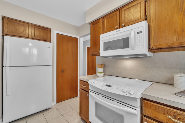 kitchen featuring white appliances and light tile patterned floors