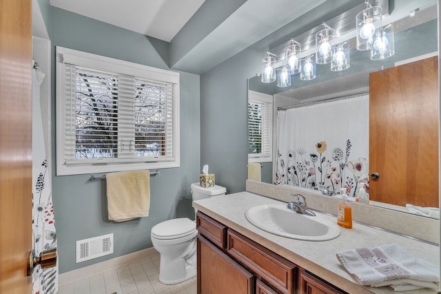 bathroom featuring toilet, vanity, and tile patterned floors