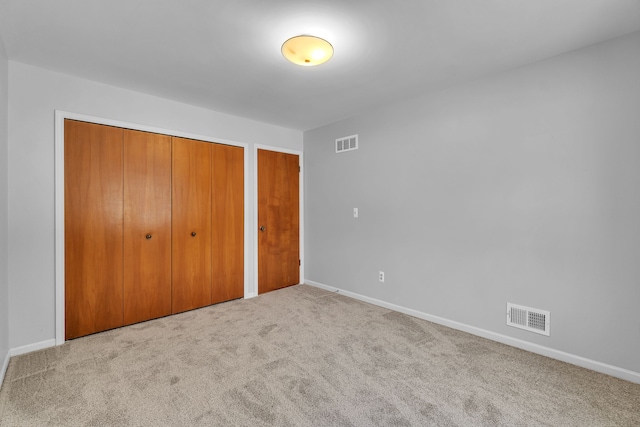 unfurnished bedroom featuring light carpet