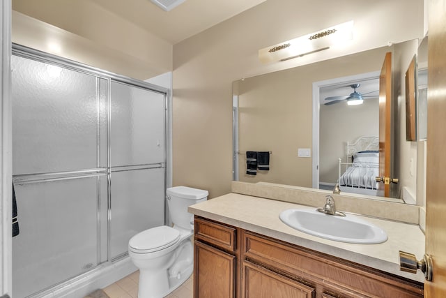 bathroom with ceiling fan, toilet, tile patterned floors, a shower with door, and vanity