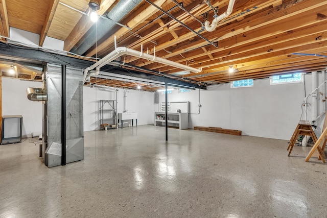 basement with sink and heating unit