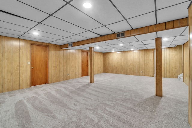 basement with wooden walls and carpet