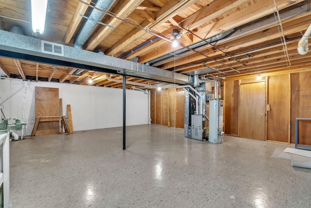 basement with water heater and heating unit