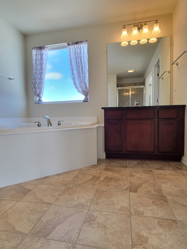 bathroom with vanity and shower with separate bathtub