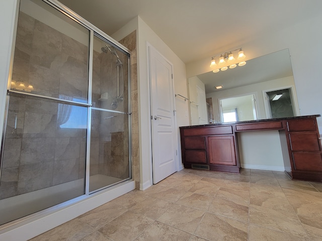 bathroom featuring vanity and a shower with door