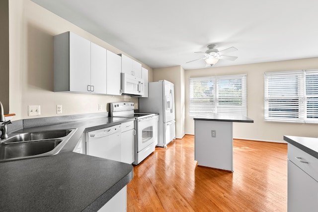 kitchen featuring white appliances, white cabinets, sink, ceiling fan, and light hardwood / wood-style flooring