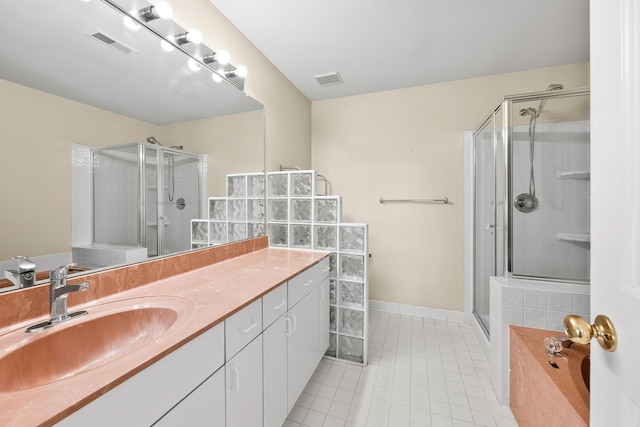 bathroom with vanity, walk in shower, and tile patterned flooring