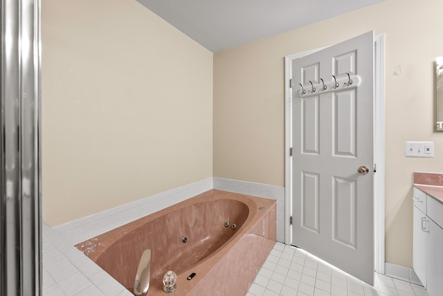 bathroom featuring a washtub, tile patterned floors, and vanity