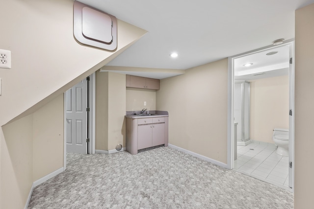 interior space with sink and light colored carpet