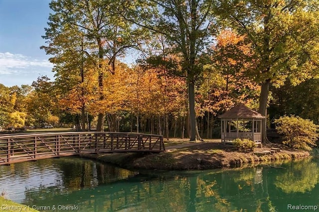 view of community with a gazebo and a water view