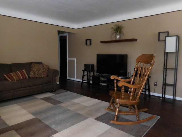 living area featuring baseboards