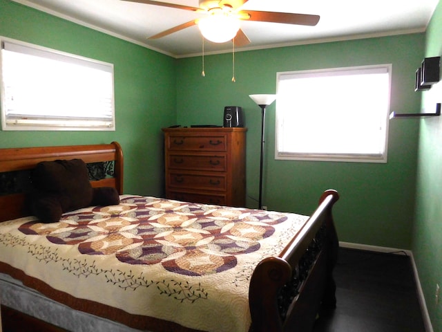 bedroom with crown molding, ceiling fan, and multiple windows