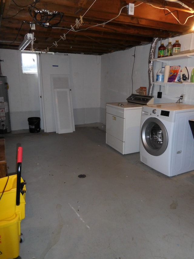 basement with water heater and washing machine and clothes dryer