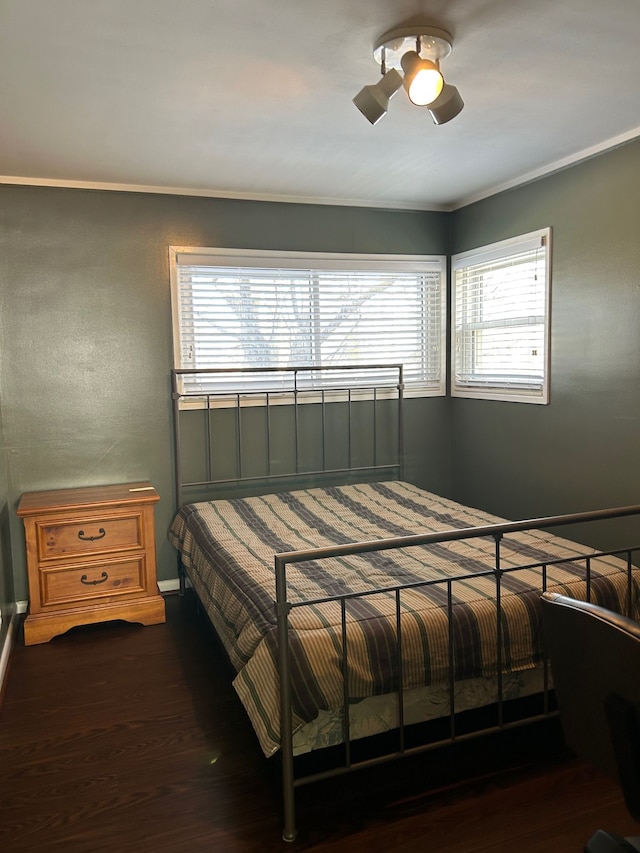 bedroom featuring ceiling fan, crown molding, and wood finished floors