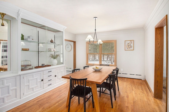 dining room featuring baseboard heating, ornamental molding, light hardwood / wood-style flooring, and a chandelier