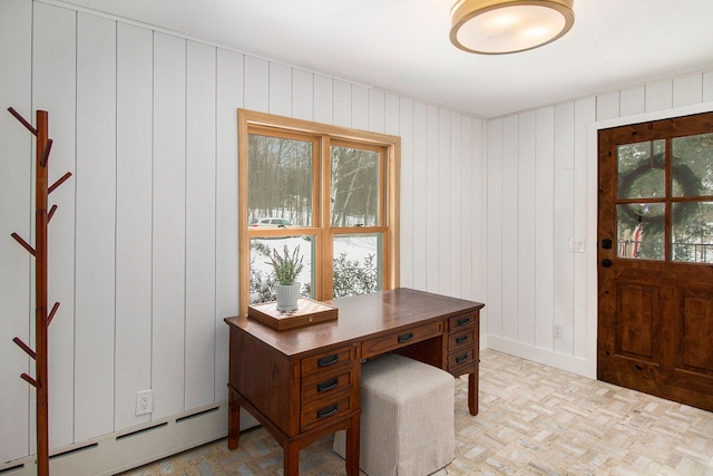 office featuring wooden walls and a baseboard heating unit