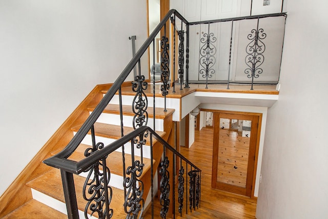 stairs featuring hardwood / wood-style floors